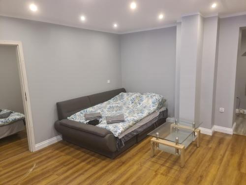 a living room with a couch and a glass table at Apartament mieszkanie do wynajęcia Nicola in Wałbrzych