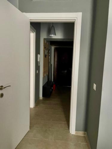 a hallway with a hallway leading into a room with green walls at Olive House in Golem