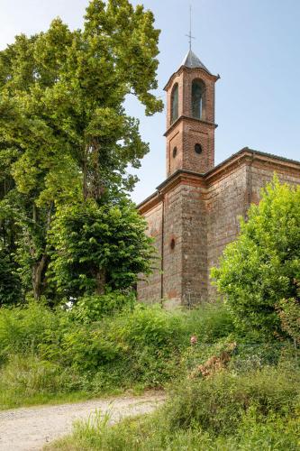 an old brick building with a clock tower on it at Notte nella Botte in Vignale Monferrato