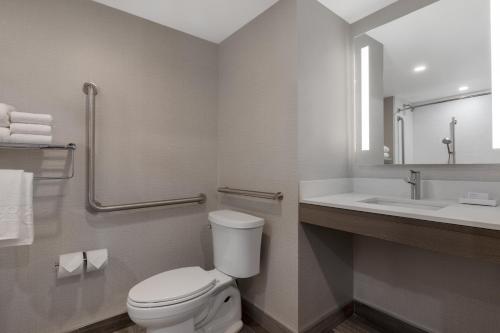a bathroom with a toilet and a sink at Home2 Suites By Hilton Kingston in Kingston