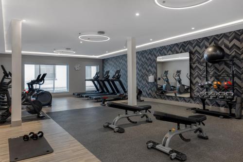 a gym with several treadmills and exercise bikes at Home2 Suites By Hilton Kingston in Kingston