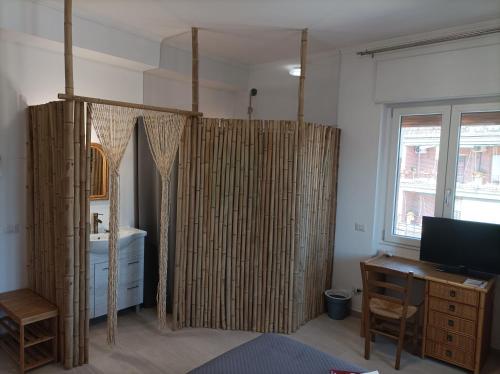 a bathroom with bamboo curtains and a sink at Roma Casetta - Tourist Rooms in Guidonia