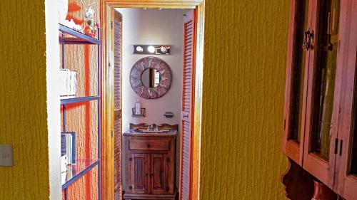 a hallway with a sink and a mirror on a wall at Villa Meli 2 in Jocotepec