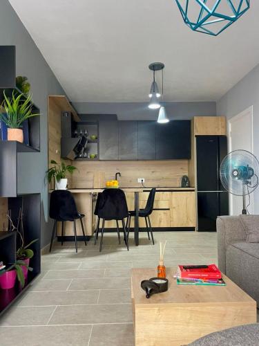 a living room with a table and a kitchen at Olive House in Golem