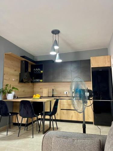 a kitchen with a table and a fan in a room at Olive House in Golem