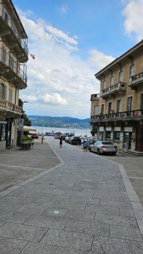 a street in a city with buildings and a kite in the sky at Casa Manzoni in Pallanza