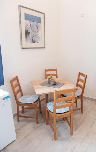 a wooden table with two chairs and a table and a picture at Panská in Chlum u Třeboně