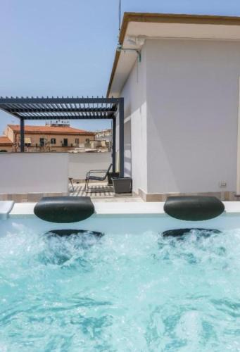 a pool of water with two black balls in it at Rooftop Parthenopeo Contemporary Rooms in Naples
