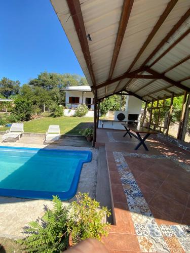 a house with a swimming pool and a pavilion at Casa Cadillal in El Cadillal