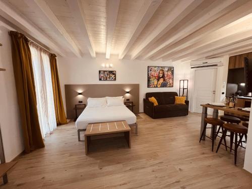 a hotel room with a bed and a couch at 5 Terre Hub Suite 1 in La Spezia