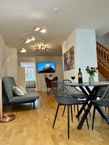 a dining room and living room with a table and chairs at Carillon by BestChoice - Old City - Self Check-in with PARKING option in Graz