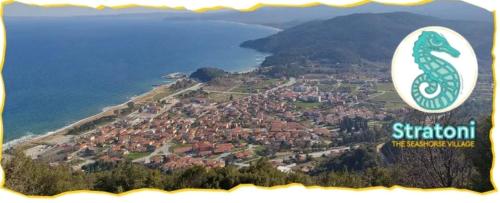 an aerial view of a town on a hill next to the water at Hippocampus House in Stratónion