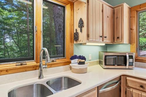 a kitchen with a sink and a microwave at Tree House in Townsend