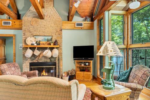 a living room with a couch and a fireplace at Tree House in Townsend