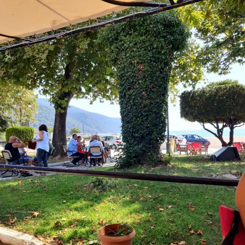 a group of people sitting in chairs in a park at Hippocampus House in Stratónion