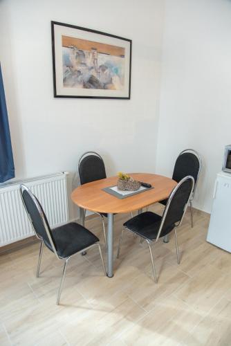 a wooden table and chairs in a room at Panská in Chlum u Třeboně