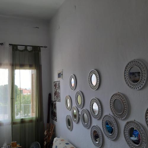 a wall with a bunch of plates on a wall at Hippocampus House in Stratónion