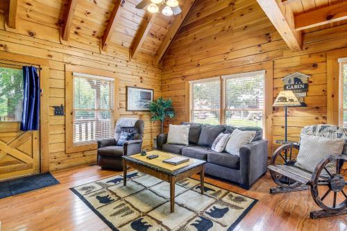 a living room with a couch and chairs in a cabin at Pigeon Forge Cabin Premier Location and Hot Tub in Pigeon Forge