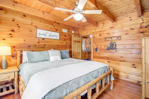 a bedroom with a bed in a log cabin at Pigeon Forge Cabin Premier Location and Hot Tub in Pigeon Forge