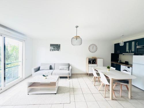 un salon avec un canapé et une table dans l'établissement Appartement des Lilas 25km de Paris et Disney, à Pontault-Combault