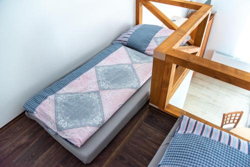 two bunk beds in a room with a ladder at Panská in Chlum u Třeboně