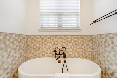 a bath tub with a faucet in a bathroom at Vista Montana Downtown Monument w BBQ & Fire Pit in Monument
