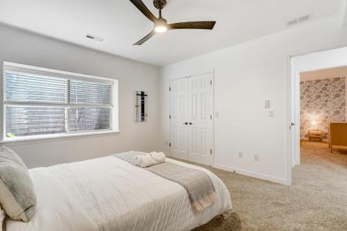 a bedroom with a bed and a ceiling fan at Vista Montana Downtown Monument w BBQ & Fire Pit in Monument
