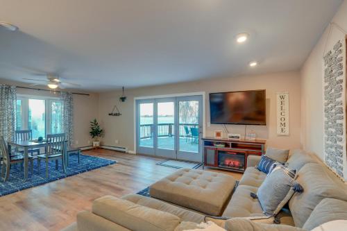 a living room with a couch and a fire place at Lakefront Fairbanks Home with Private Beach! in Fairbanks