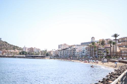 a view of a beach with buildings and people on it at Apartamentos Sol de Águilas in Águilas