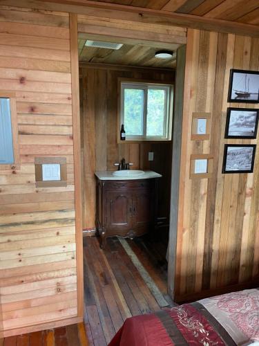 a bathroom with a sink in a wooden cabin at Fishermans Folly in Lund