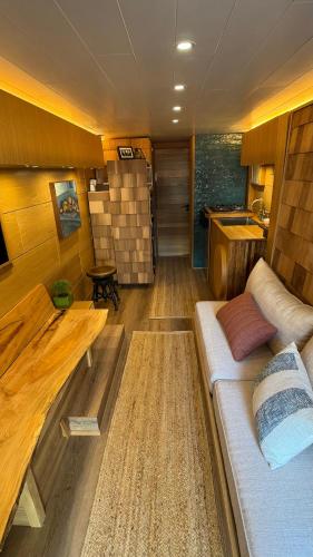 a living room with a couch and a table at City Hideaway, Off Grid Luxe in Lancaster