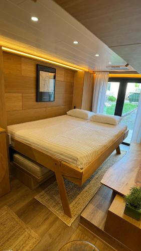 a bedroom with a large bed on a boat at City Hideaway, Off Grid Luxe in Lancaster