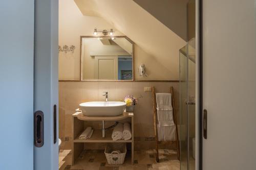 a bathroom with a sink and a mirror at Palascìa Wellness Relais in Otranto