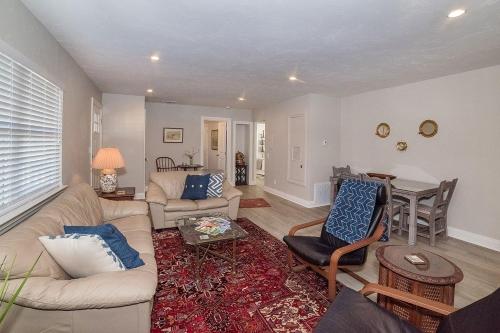 a living room with a couch and a table at Anchorage Haus in Fredericksburg