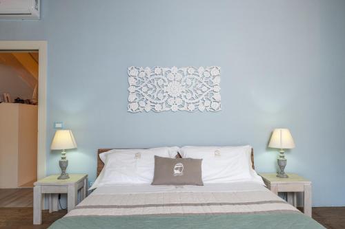 a bedroom with a large bed with two tables at Palascìa Wellness Relais in Otranto