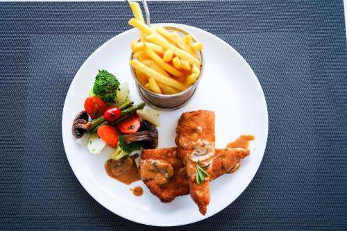 a plate of food with meat and french fries at AZ hôtel des arts in Rabat