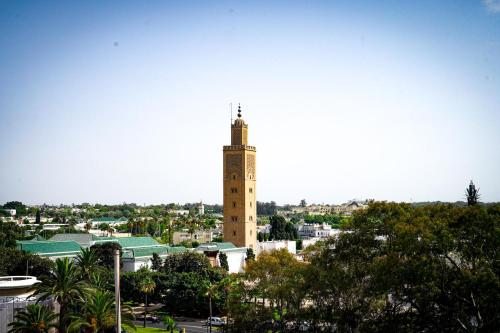 a tall building with a clock tower in a city at AZ hôtel des arts in Rabat