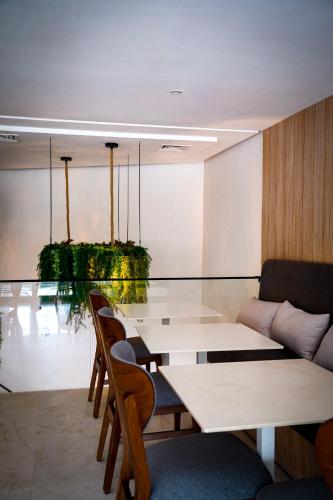 a dining room with a glass table and chairs at AZ hôtel des arts in Rabat