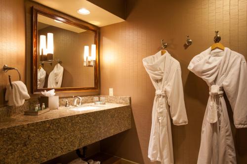 a bathroom with a sink and a mirror and towels at Ventana Canyon Club and Lodge in Tucson
