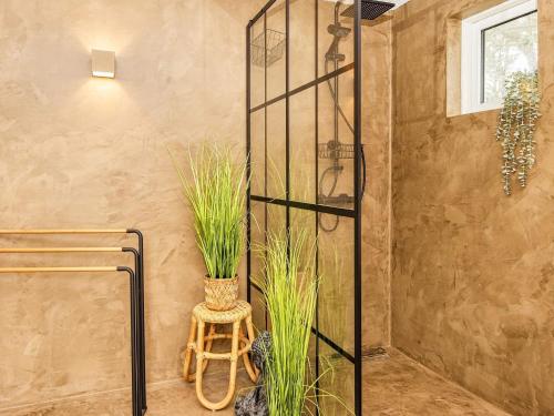 a bathroom with a glass shower with plants in it at Dune Escape with Games and WiFi-By Traum in Bjerregård