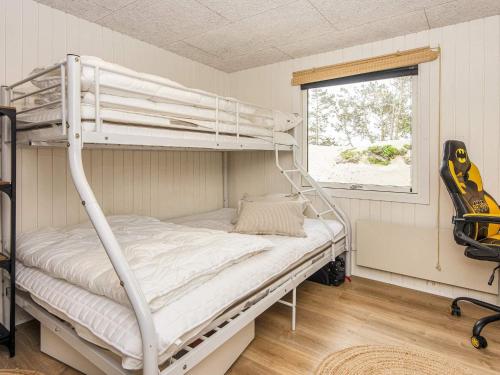 a bedroom with a bunk bed and a window at Dune Escape with Games and WiFi-By Traum in Bjerregård