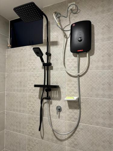a shower with a blow dryer in a bathroom at 2BR Apartment - Beachfront - Corner Unit - Netflix - Unifi 300mbps - Mutiara Melaka Pantai Puteri in Malacca