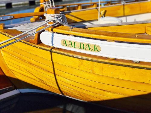a yellow boat with the name alabak written on it at 6 person holiday home in Ålbæk-By Traum in Ålbæk