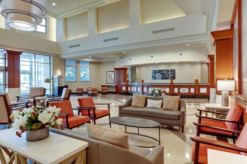a lobby with couches and tables and chairs at Drury Plaza Hotel Nashville Franklin in Franklin