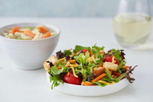 a salad in a white bowl on a table at Drury Plaza Hotel Nashville Franklin in Franklin