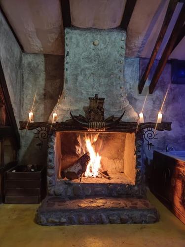 a stone fireplace with a fire in it at Hoguera del Nómada in Santo Domingo
