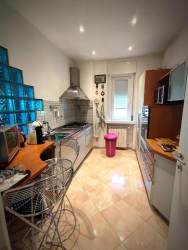 a kitchen with a counter and some chairs in it at Charme&Chic in Trieste