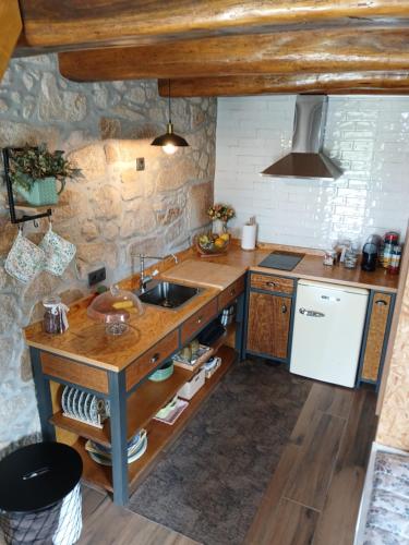 a kitchen with a sink and a counter top at In Costa House - Alojamento Barcelos in Barcelos