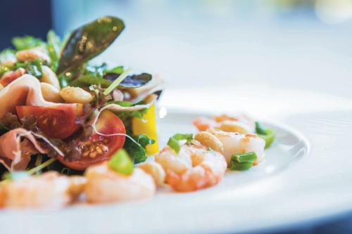 a plate of food with shrimp on a table at Riu Plaza Berlin in Berlin