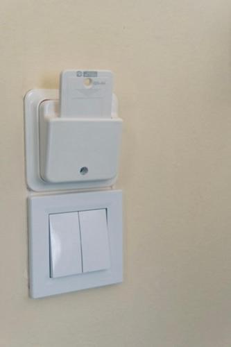 a white object on a wall with a box at Aurora Apartments in Mytilini